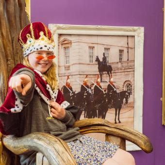 Girl dressed up as a royal posing